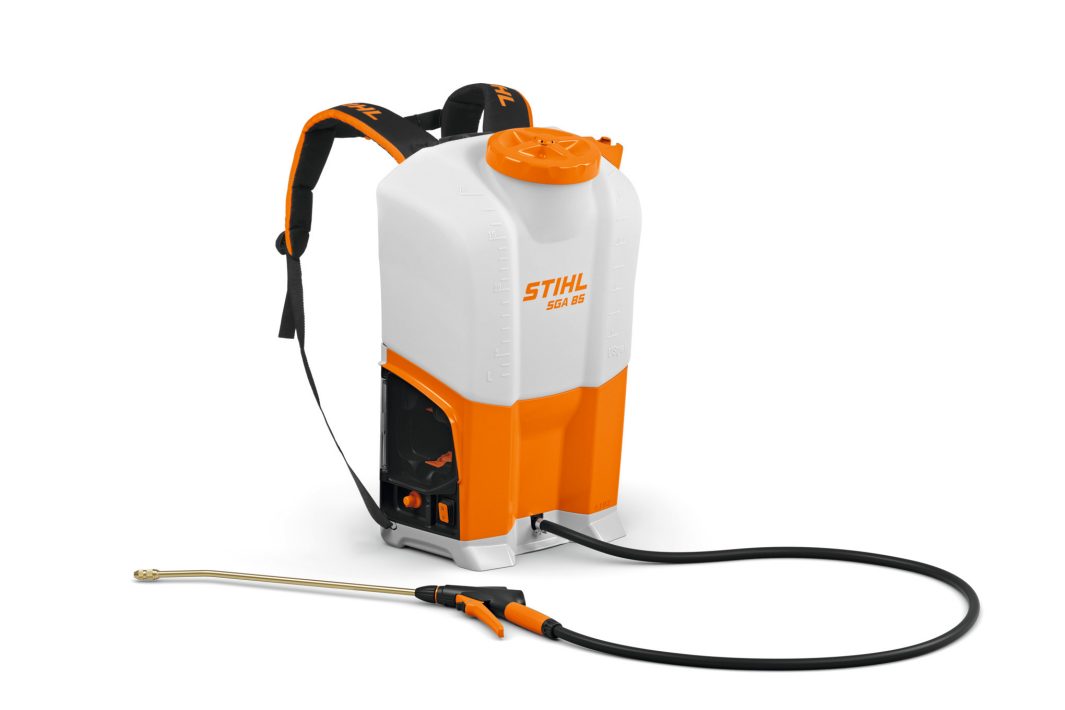 The Stihl SGA 85.0 (AP) Sprayer has a brass lance, padded straps, side handle, and black hose in a white and orange rucksack design.
