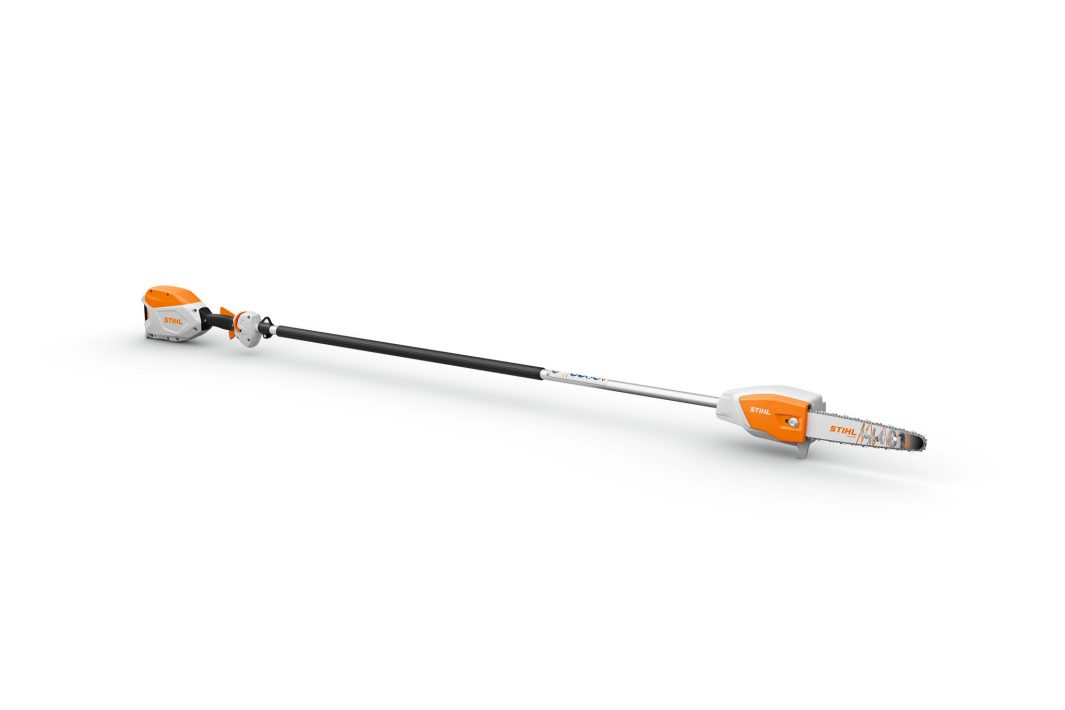 A battery-powered pole saw with an orange and white motor housing and a small chainsaw blade, connected by a long black shaft.