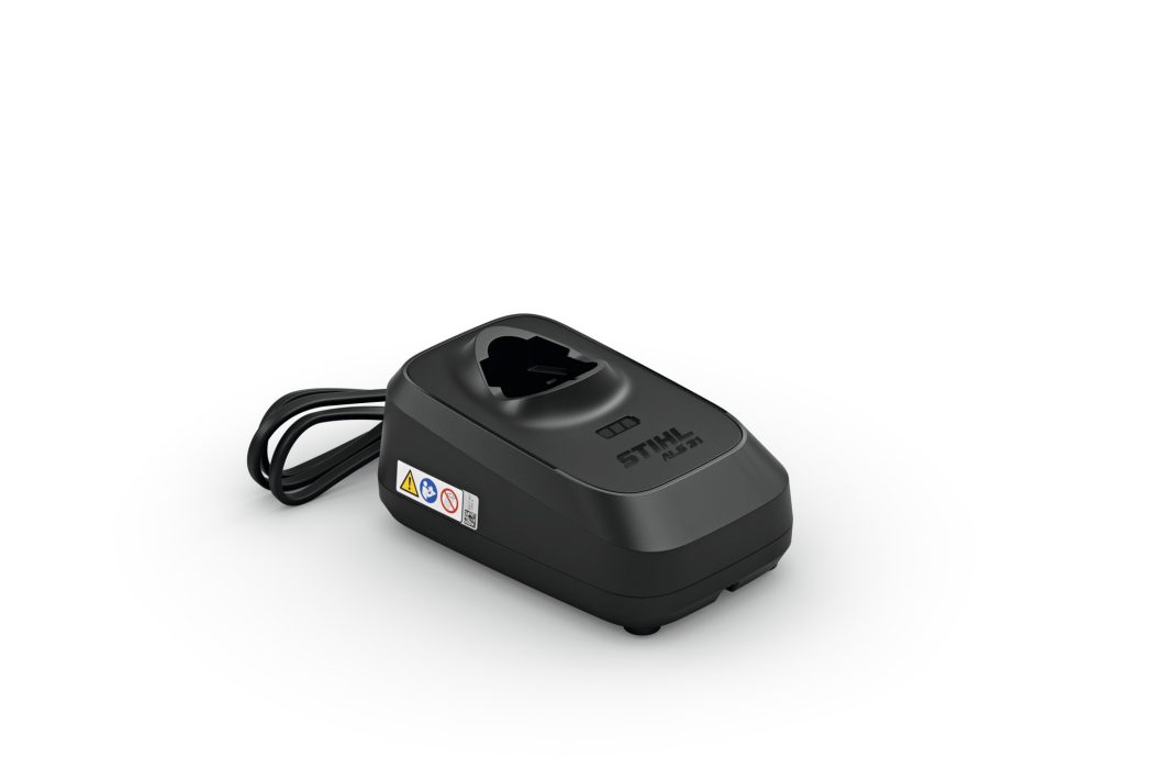A black STIHL battery charger with a power lead, indicator lights, and safety labels on a plain white background.