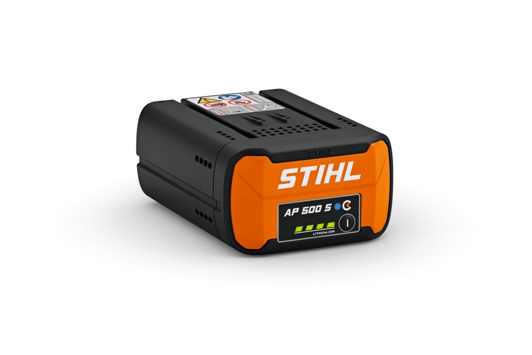 A black and orange STIHL AP 500 S lithium-ion battery with indicator lights, vents, and warning labels on a white background.