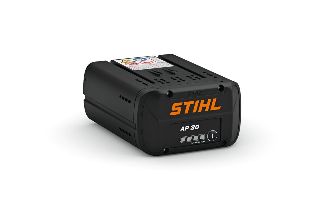 A black STIHL AP 300 battery with orange branding, indicator lights, and safety label on top, designed for power tools on white.