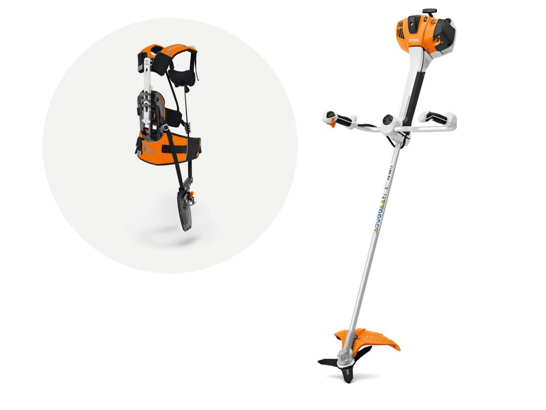 An orange and silver Stihl FS 491.0 C-EM brushcutter with straight shaft, new handlebar grips, and padded harness with metal fittings.