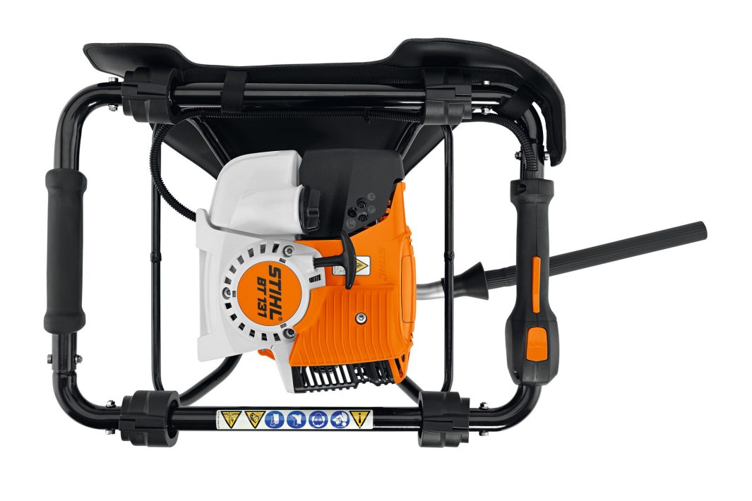 The Stihl BT 131 Earth Auger in orange and white, shown from above with black frame, side handles, pull start, and safety symbols.
