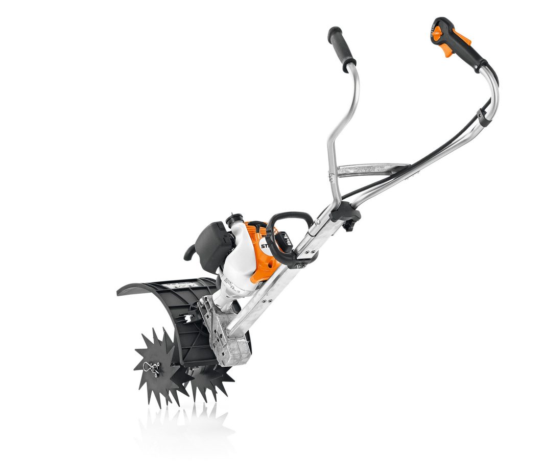 The Stihl MM 56 MultiEngine & Wheel Kit shows a white and orange tiller with black handles, metal tines, and a wheel kit on white.