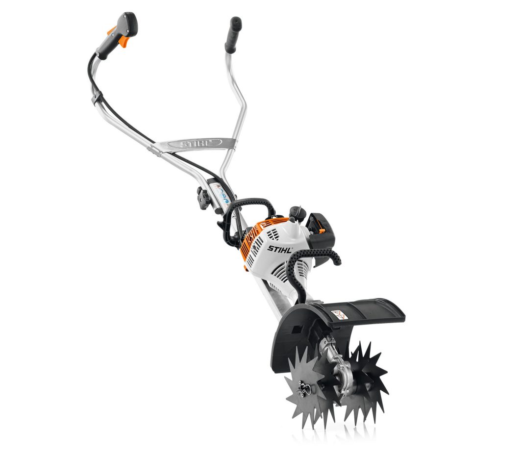 The Stihl MM 56 MultiEngine & Wheel Kit has metal tines, curved handles, and a black-orange design for tilling small gardens.