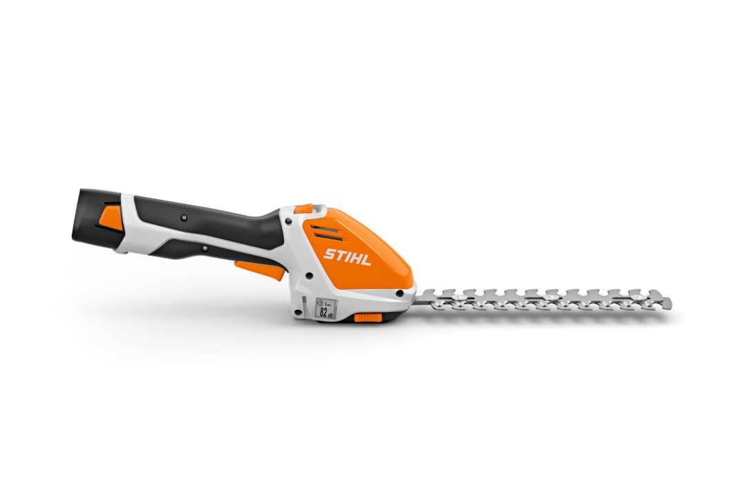 The Stihl HSA 26 (AS) Trimmer (No Batt/Charger), displayed in side profile with an orange, white, and black body on a white background.