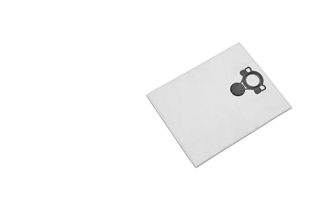 A single white vacuum cleaner bag with a black plastic fitting sits slightly off-centre to the right on a plain white background.