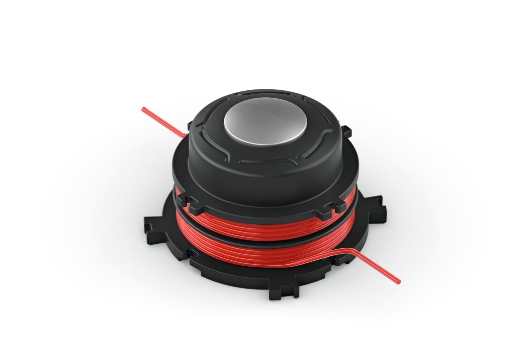 A black plastic spool with red wire neatly wound round it, two wire ends visible, placed on a plain white background.
