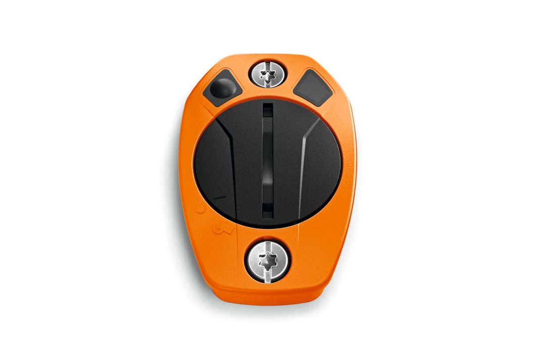 An orange and black electronic key fob featuring a circular centre button and two metal screws, shown on a white background.
